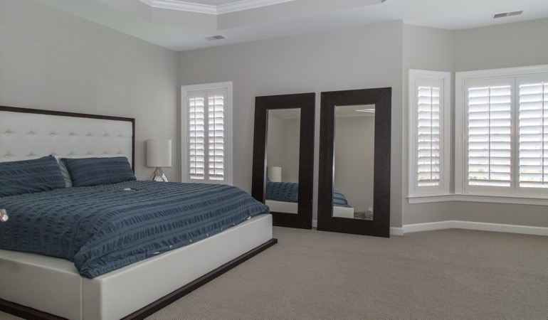 Polywood shutters in a minimalist bedroom in Houston.